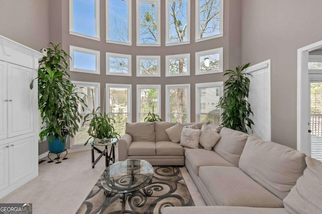 5810 Old Mill Trce, Lithonia, GA 30038 - living room featuring light colored carpet, plenty of natural light, and a towering ceiling