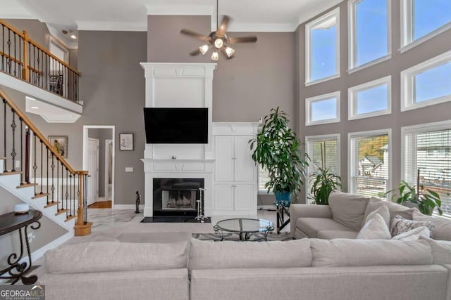 5810 Old Mill Trce, Lithonia, GA 30038 - living room featuring a high ceiling, a fireplace with flush hearth, healthy amount of natural light, and stairway