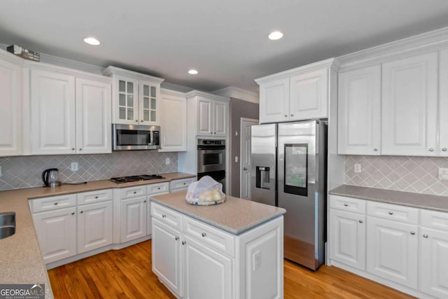 5810 Old Mill Trce, Lithonia, GA 30038 - kitchen featuring stainless steel appliances, white cabinetry, light wood-style floors, tasteful backsplash, and recessed lighting