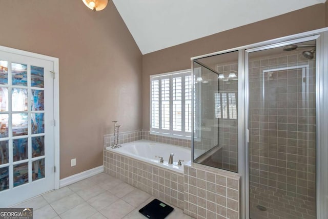 5810 Old Mill Trce, Lithonia, GA 30038 - bathroom with vaulted ceiling, tile patterned floors, a garden tub, a stall shower, and baseboards