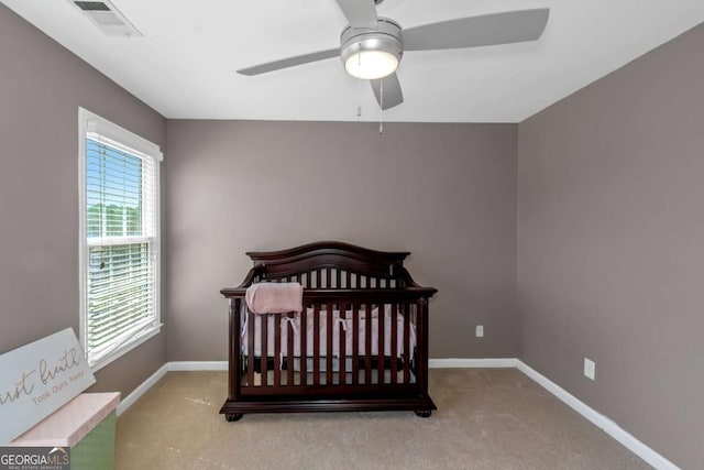 5810 Old Mill Trce, Lithonia, GA 30038 - carpeted bedroom with baseboards, a ceiling fan, and a nursery area