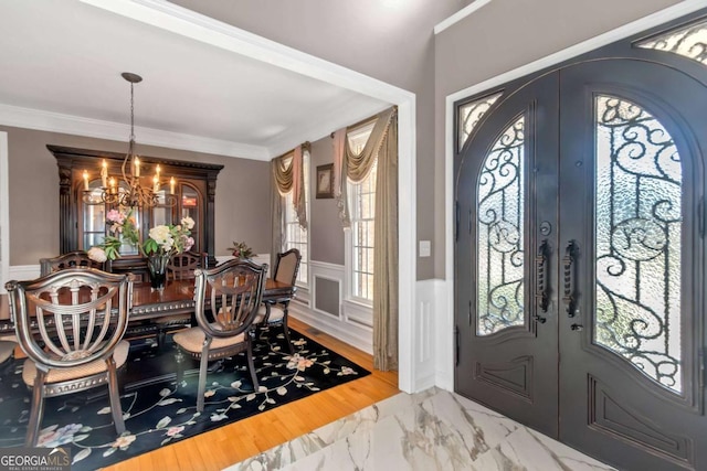 5810 Old Mill Trce, Lithonia, GA 30038 - entrance foyer with french doors, a chandelier, wainscoting, marble finish floors, and ornamental molding