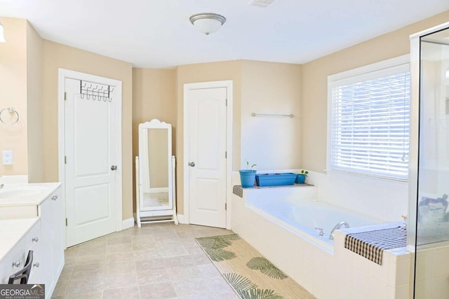 330 Bay Grove Rd, Loganville, GA 30052 - full bath with vanity, a garden tub, and a shower stall