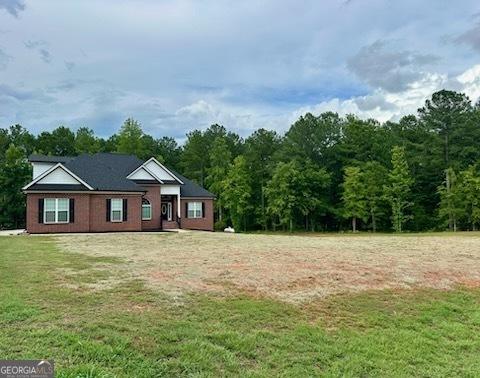 2594 Lassiter Rd, Forsyth, GA 31029 - view of grassy yard featuring a forest view