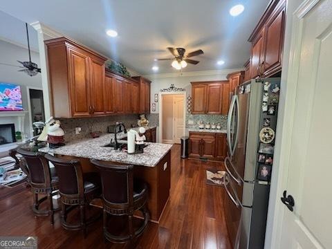 2594 Lassiter Rd, Forsyth, GA 31029 - kitchen featuring a ceiling fan, freestanding refrigerator, a peninsula, tasteful backsplash, and recessed lighting