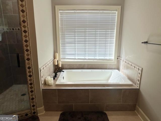 2594 Lassiter Rd, Forsyth, GA 31029 - bathroom featuring a bath and a stall shower