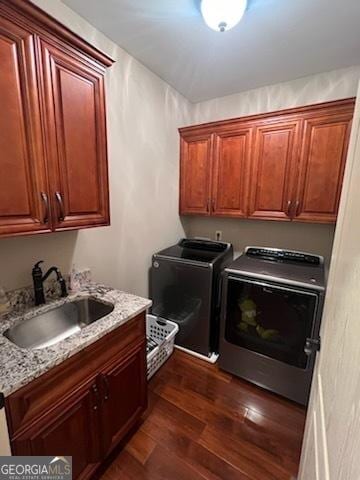 2594 Lassiter Rd, Forsyth, GA 31029 - laundry area with cabinet space, washing machine and dryer, and dark wood-style flooring