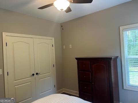 2594 Lassiter Rd, Forsyth, GA 31029 - bedroom featuring multiple windows, baseboards, a closet, and ceiling fan