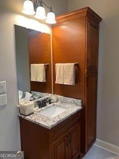2594 Lassiter Rd, Forsyth, GA 31029 - bathroom featuring vanity, a chandelier, and baseboards