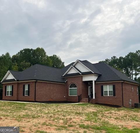 2594 Lassiter Rd, Forsyth, GA 31029 - ranch-style home with brick siding and a front lawn