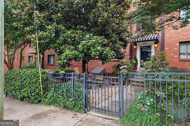 330 3rd St NE Apt 1, Atlanta, GA 30308 - view of front facade with brick siding, a fenced front yard, and a gate