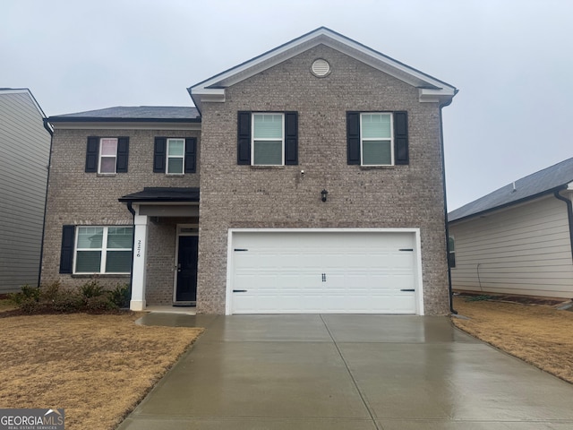 2276 Waycross Ln Unit 21, Dacula, GA 30019 - view of front of house with concrete driveway, an attached garage, and brick siding