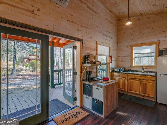 721 Dial Rd, Blue Ridge, GA 30513 - kitchen with freestanding refrigerator, a sink, dark wood finished floors, wood walls, and dark countertops