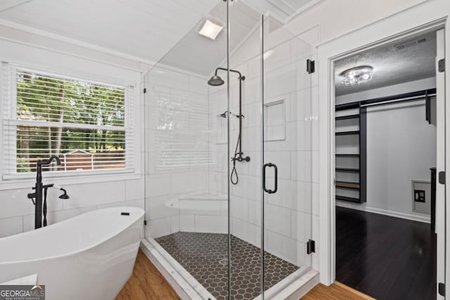 125 Sable Pointe Dr, Milton, GA 30004 - full bathroom featuring wood finished floors, a freestanding bath, a stall shower, and vaulted ceiling
