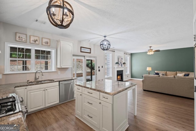 125 Sable Pointe Dr, Milton, GA 30004 - kitchen featuring dishwasher, a sink, a chandelier, white cabinets, and wood finished floors