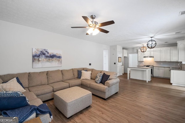 125 Sable Pointe Dr, Milton, GA 30004 - living area with wood finished floors and a ceiling fan