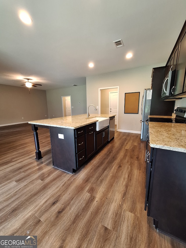 489 Asbury Mill Rd, Cleveland, GA 30528 - kitchen with appliances with stainless steel finishes, a sink, a kitchen island with sink, dark wood finished floors, and baseboards