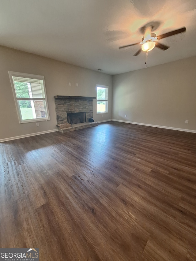 489 Asbury Mill Rd, Cleveland, GA 30528 - unfurnished living room with dark wood-style floors, a fireplace, a ceiling fan, and baseboards