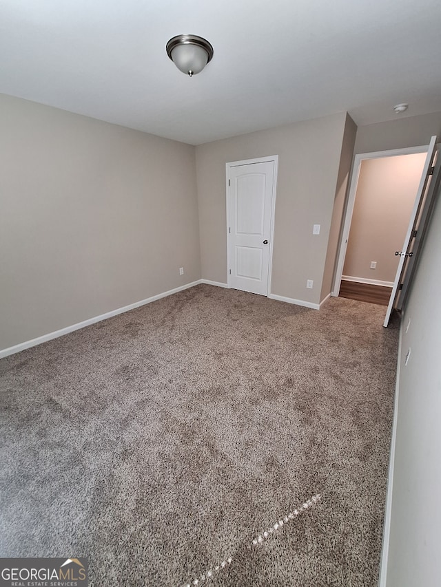 489 Asbury Mill Rd, Cleveland, GA 30528 - spare room featuring baseboards and carpet