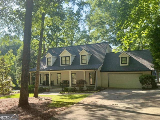 163 Martin Oaks Blvd, Eatonton, GA 31024 - cape cod-style house featuring a porch, a garage, and driveway