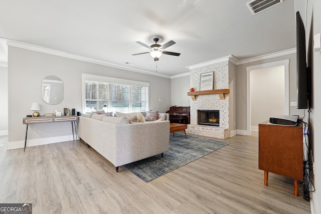 2441 Waterside Dr, Monroe, GA 30655 - living room with ornamental molding, a ceiling fan, wood finished floors, a fireplace, and baseboards