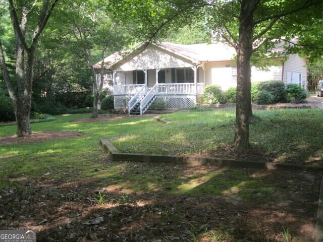 304 Tunis Rd, Mcdonough, GA 30253 - view of front of property with covered porch, a front lawn, and stairs