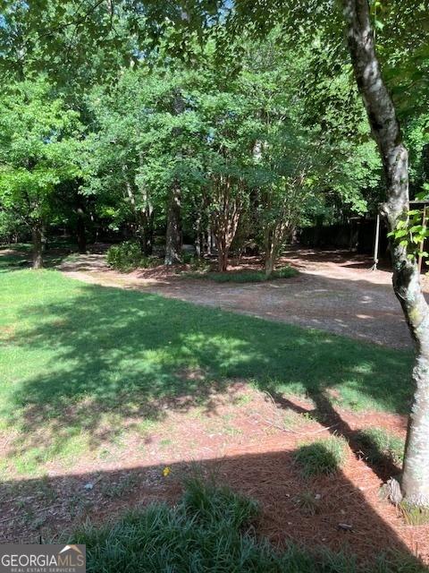 304 Tunis Rd, Mcdonough, GA 30253 - view of grassy yard featuring a patio area