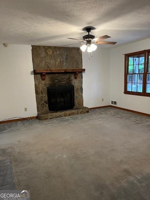 304 Tunis Rd, Mcdonough, GA 30253 - unfurnished living room featuring baseboards, a ceiling fan, a textured ceiling, carpet flooring, and a fireplace