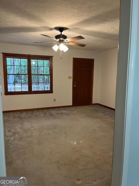 304 Tunis Rd, Mcdonough, GA 30253 - spare room featuring baseboards, ceiling fan, a textured ceiling, and carpet floors