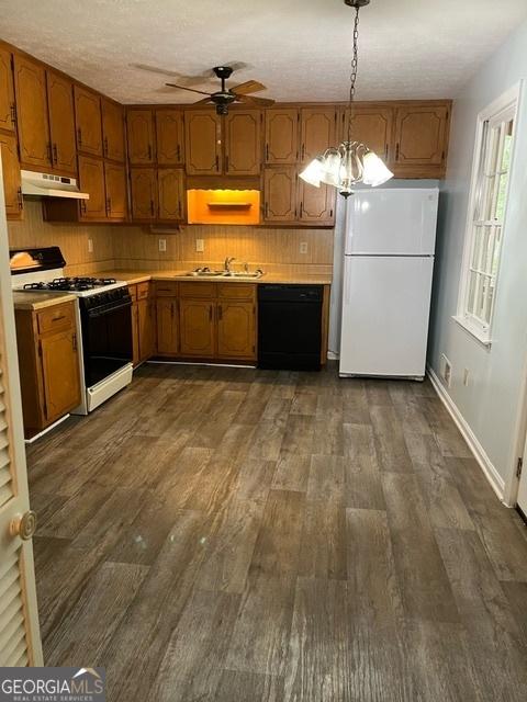 304 Tunis Rd, Mcdonough, GA 30253 - kitchen with freestanding refrigerator, gas stove, black dishwasher, ceiling fan, and brown cabinetry