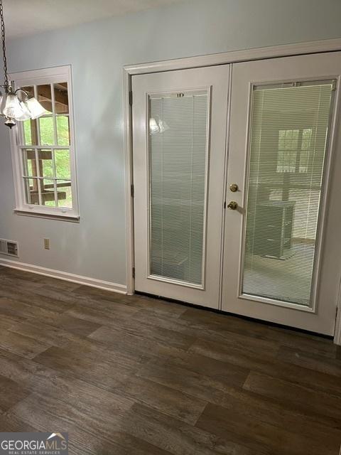 304 Tunis Rd, Mcdonough, GA 30253 - entryway featuring dark wood-style flooring, baseboards, french doors, and a chandelier