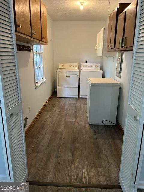 304 Tunis Rd, Mcdonough, GA 30253 - laundry area with separate washer and dryer, cabinet space, dark wood finished floors, and baseboards