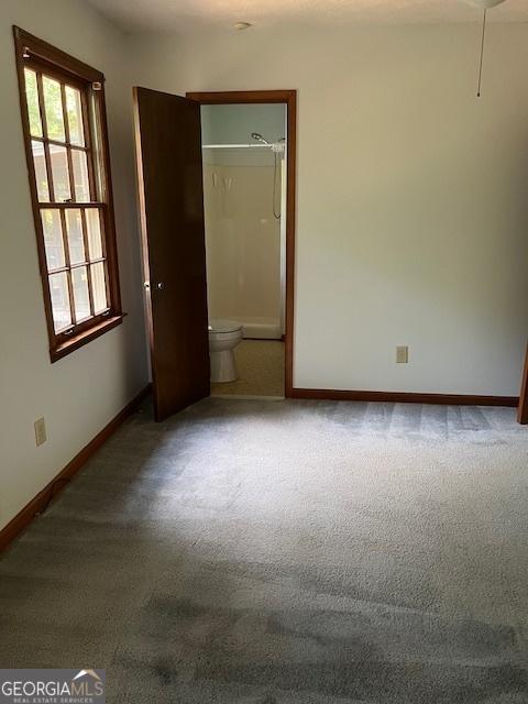 304 Tunis Rd, Mcdonough, GA 30253 - unfurnished bedroom with carpet floors and baseboards