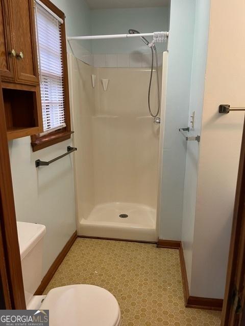 304 Tunis Rd, Mcdonough, GA 30253 - full bath with toilet, baseboards, and a shower stall