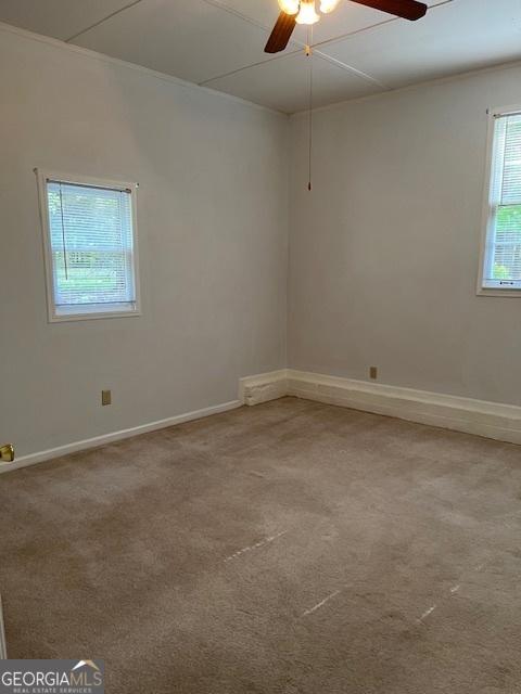 304 Tunis Rd, Mcdonough, GA 30253 - empty room with ceiling fan, light carpet, and baseboards