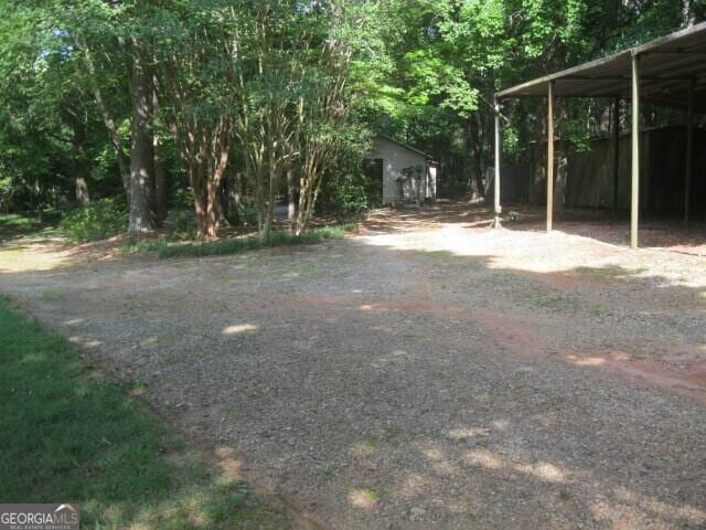 304 Tunis Rd, Mcdonough, GA 30253 - view of yard featuring dirt driveway and a detached carport