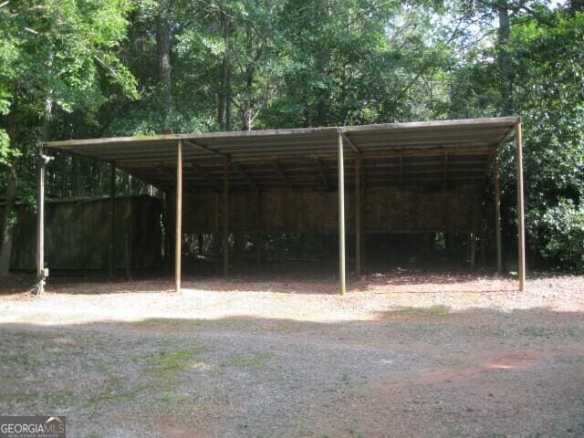 304 Tunis Rd, Mcdonough, GA 30253 - view of vehicle parking featuring a detached carport