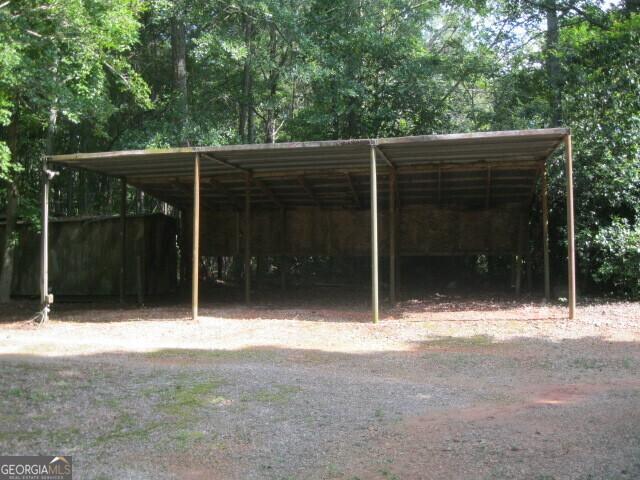 304 Tunis Rd, Mcdonough, GA 30253 - view of parking featuring a carport
