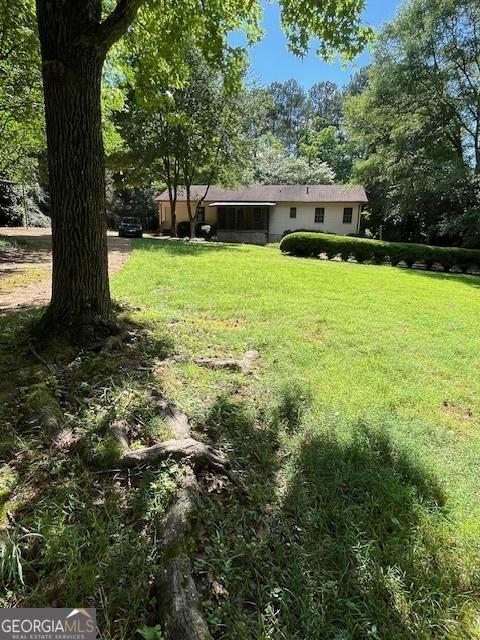 304 Tunis Rd, Mcdonough, GA 30253 - view of grassy yard featuring view of wooded area
