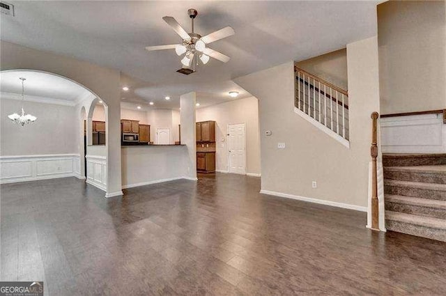 2280 Copper Trail Ln, Buford, GA 30519 - unfurnished living room with dark wood finished floors, a ceiling fan, stairs, crown molding, and wainscoting