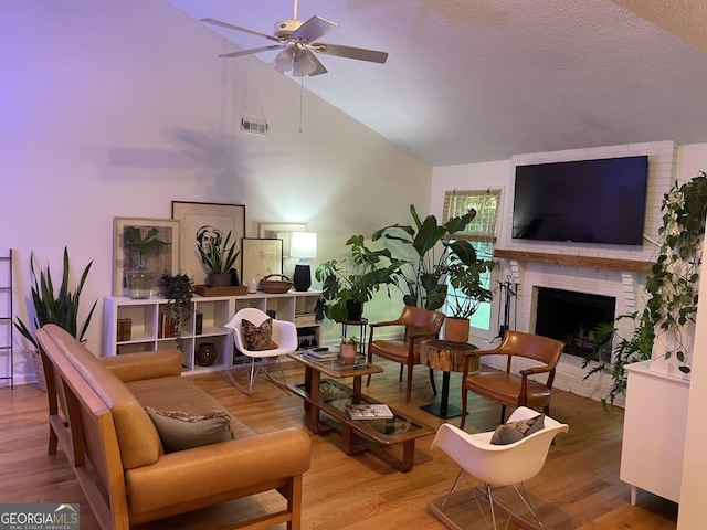 211 Groveland Dr, Peachtree City, GA 30269 - living area featuring a ceiling fan, a fireplace, lofted ceiling, wood finished floors, and a textured ceiling