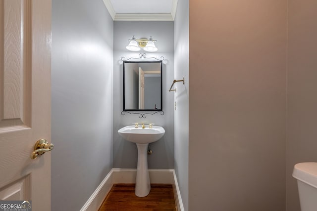 1650 Vintage Club Dr, Greensboro, GA 30642 - half bathroom with wood finished floors, ornamental molding, toilet, and baseboards