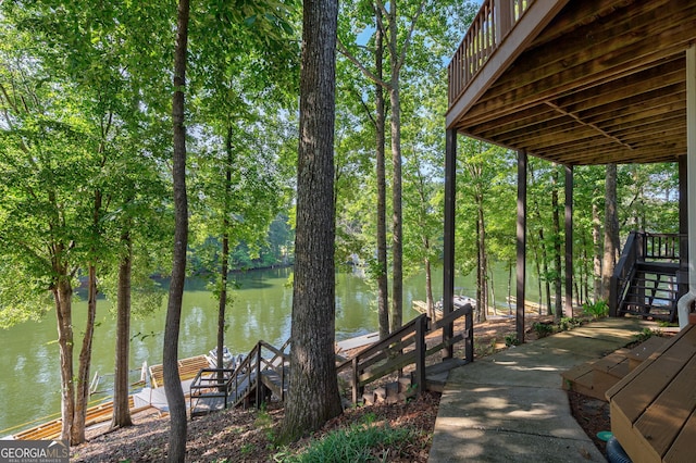1650 Vintage Club Dr, Greensboro, GA 30642 - dock featuring a water view, stairs, and view of wooded area
