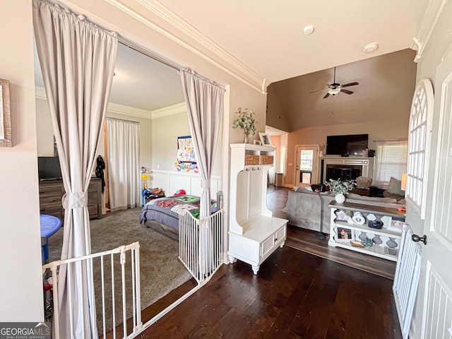 125 Kayla Ct, Locust Grove, GA 30248 - living area featuring a ceiling fan, ornamental molding, hardwood / wood-style flooring, a fireplace, and vaulted ceiling