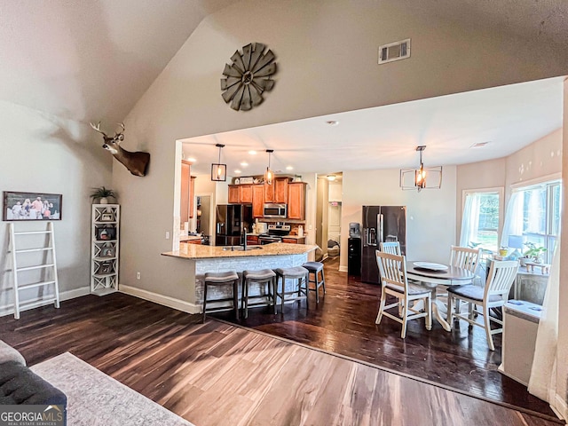 125 Kayla Ct, Locust Grove, GA 30248 - living room with dark wood-style flooring, baseboards, and lofted ceiling