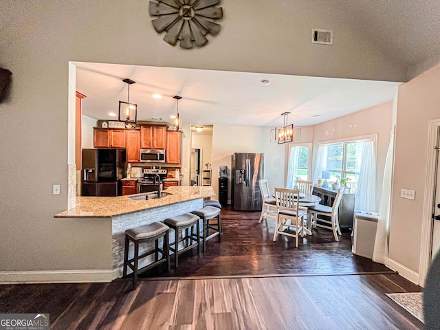 125 Kayla Ct, Locust Grove, GA 30248 - kitchen featuring stainless steel appliances, dark wood-style floors, a chandelier, and baseboards