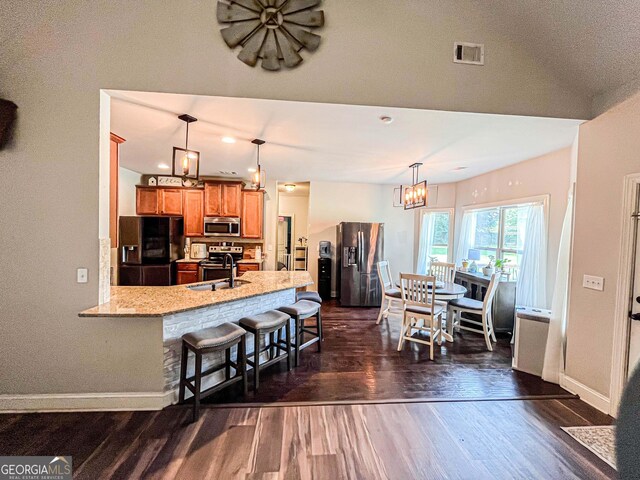 125 Kayla Ct, Locust Grove, GA 30248 - kitchen featuring stainless steel appliances, dark wood-style floors, a chandelier, and baseboards