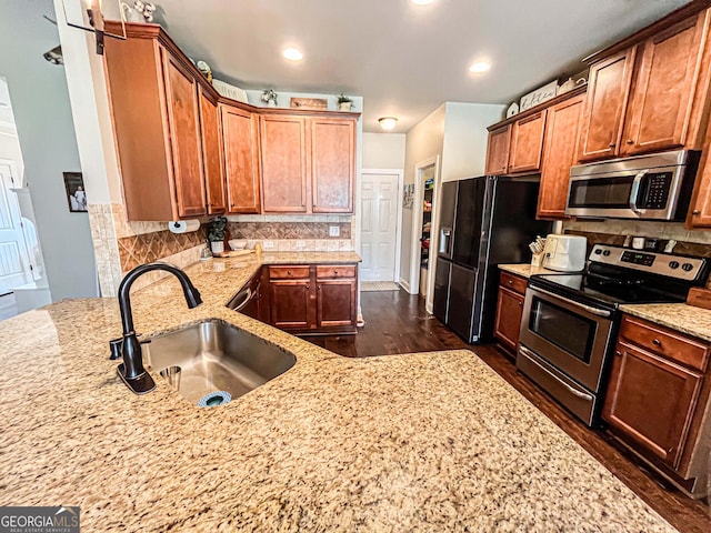 125 Kayla Ct, Locust Grove, GA 30248 - kitchen featuring stainless steel appliances, a sink, dark wood-style floors, and light stone countertops