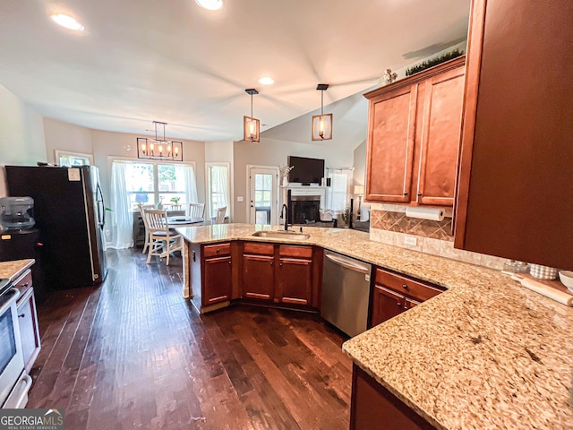125 Kayla Ct, Locust Grove, GA 30248 - kitchen with stainless steel appliances, a sink, a peninsula, dark wood finished floors, and light stone counters