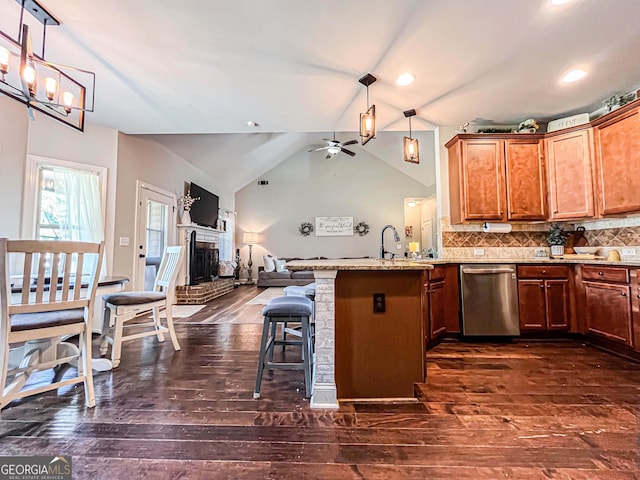 125 Kayla Ct, Locust Grove, GA 30248 - kitchen featuring stainless steel dishwasher, open floor plan, a peninsula, dark wood-type flooring, and ceiling fan